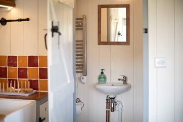 The en suite shower-room sits to the right of the hut.