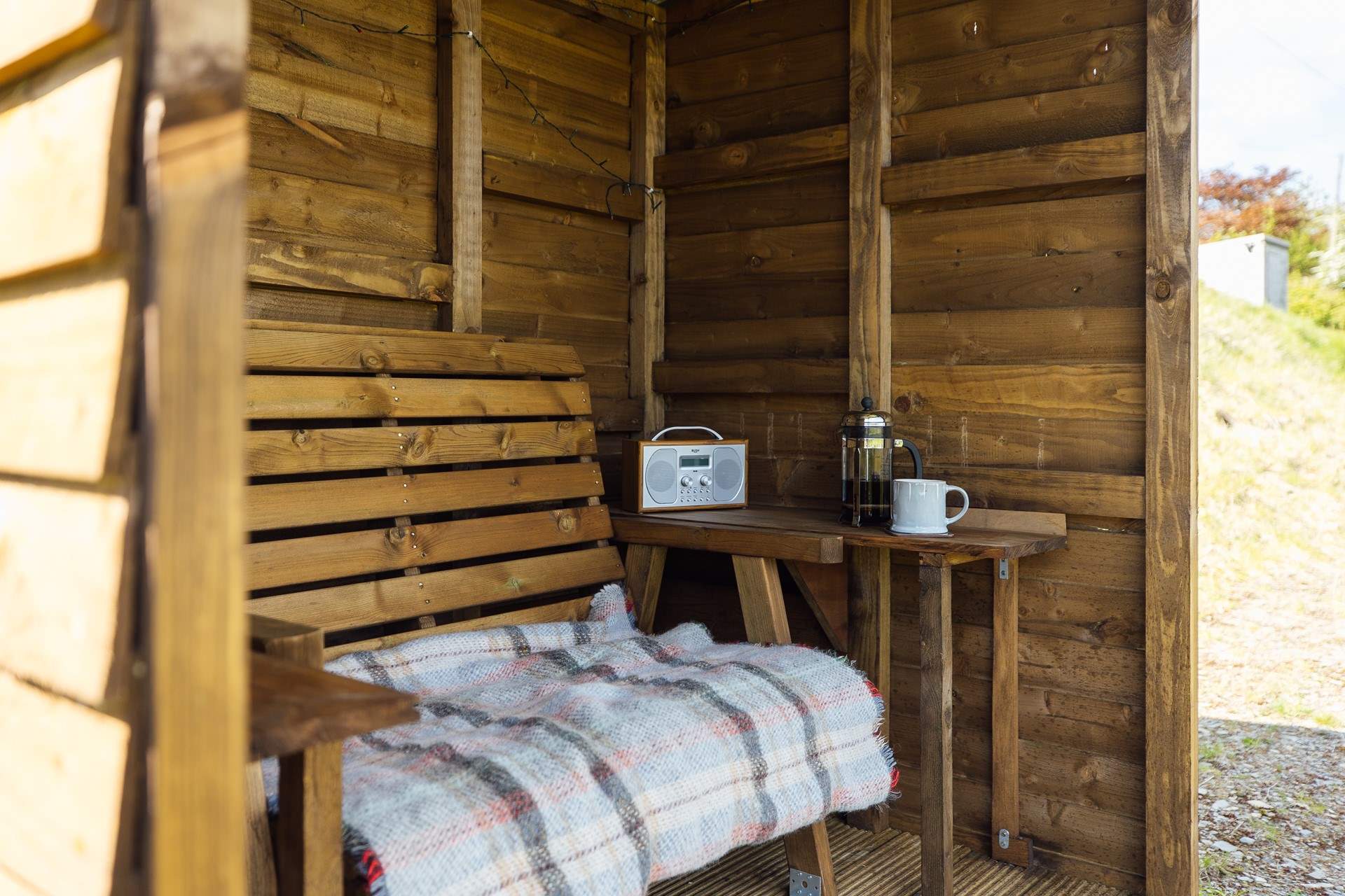The handcrafted shelter allows you space to sit out and enjoy the views, whatever the weather. 