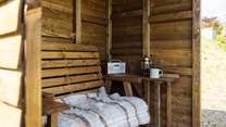 The handcrafted shelter allows you space to sit out and enjoy the views, whatever the weather. 
