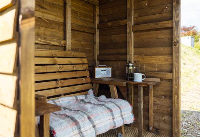 The handcrafted shelter allows you space to sit out and enjoy the views, whatever the weather. 