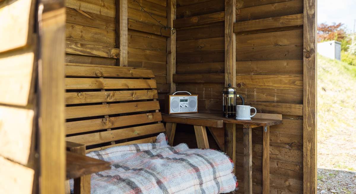 The handcrafted shelter allows you space to sit out and enjoy the views, whatever the weather. 