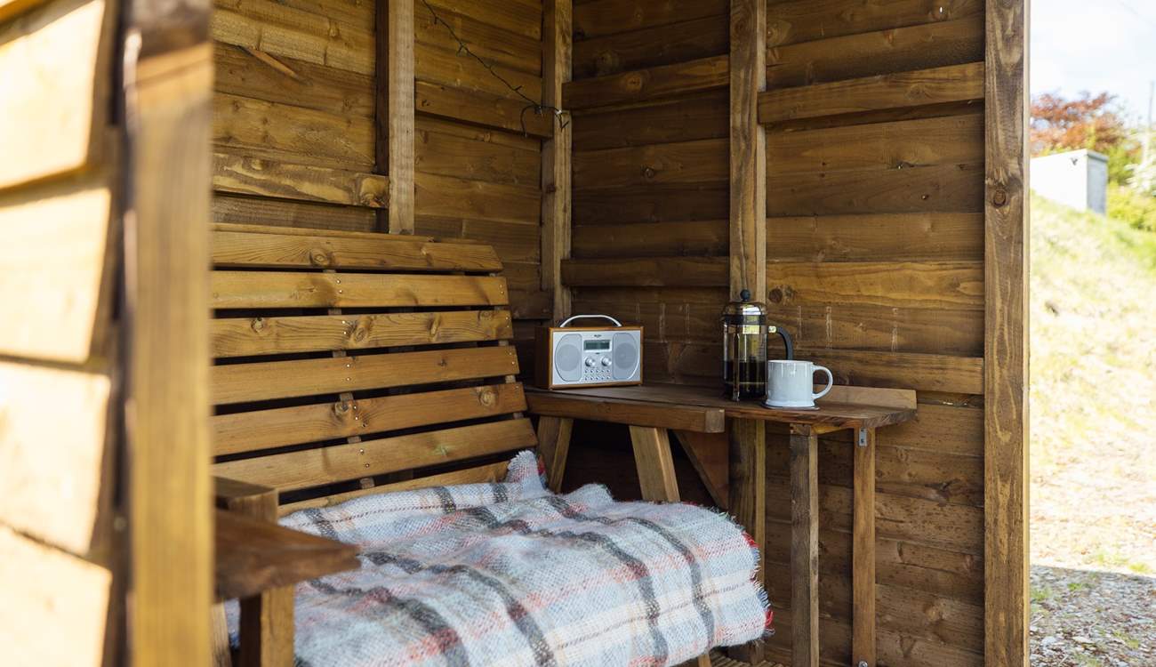 The handcrafted shelter allows you space to sit out and enjoy the views, whatever the weather. 