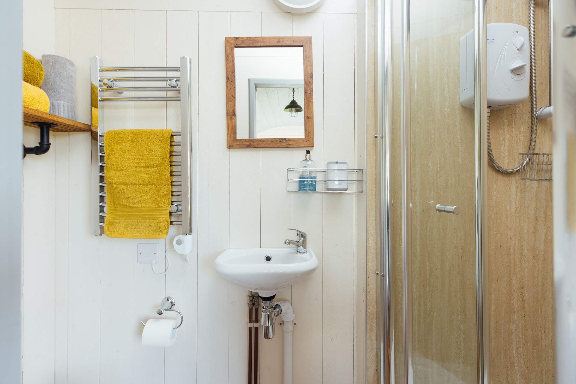 The en suite shower room sits to the right of the hut. 