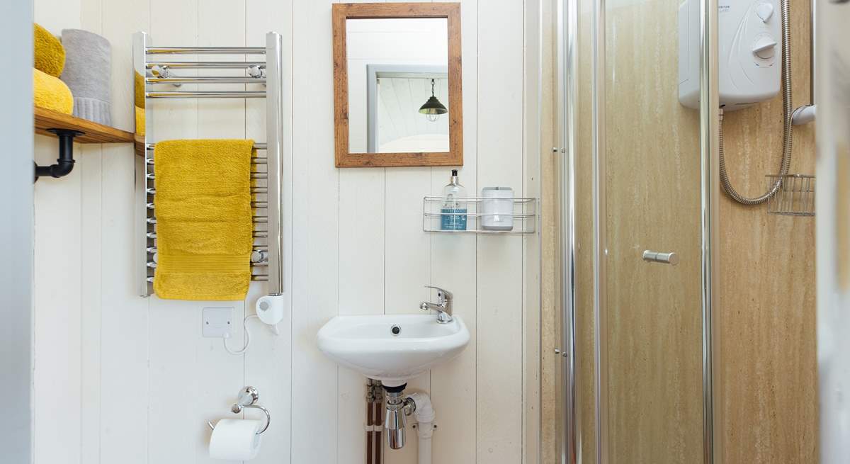 The en suite shower room sits to the right of the hut. 
