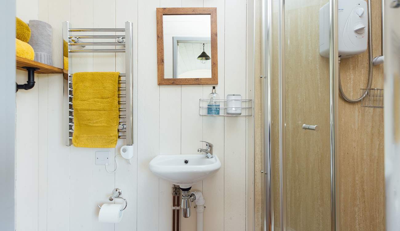 The en suite shower room sits to the right of the hut. 