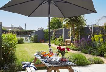 Alfresco dining on the patio, surrounded by the well tended garden.