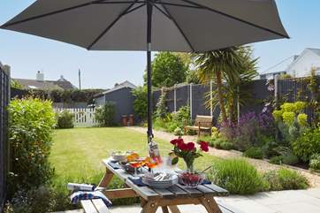 Alfresco dining on the patio, surrounded by the well tended garden.