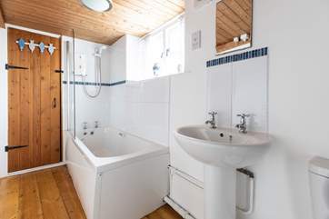 The family bathroom has a bath with shower over.