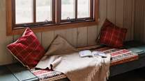 This bench seating area can be transformed into a single bed if you have a little one with you.