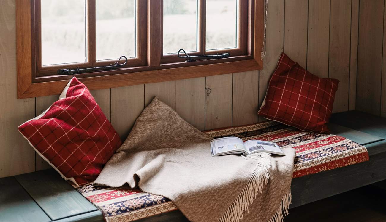 This bench seating area can be transformed into a single bed if you have a little one with you.