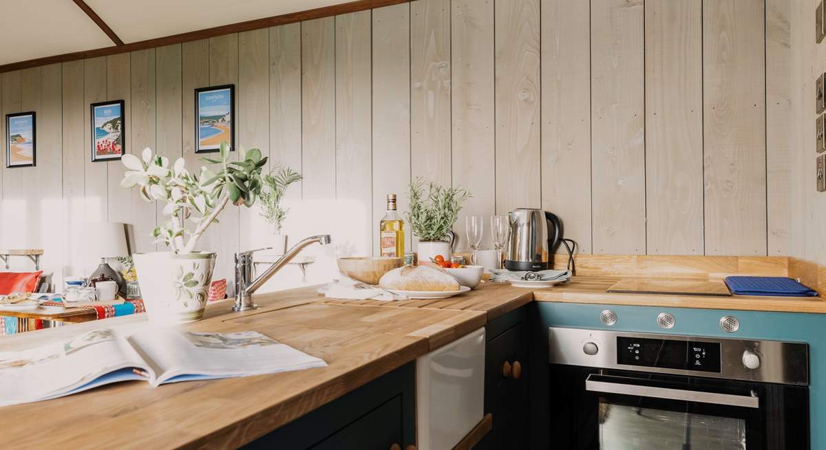 Rustle up a delicious meal in the kitchen, covering the sink for extra countertop space!