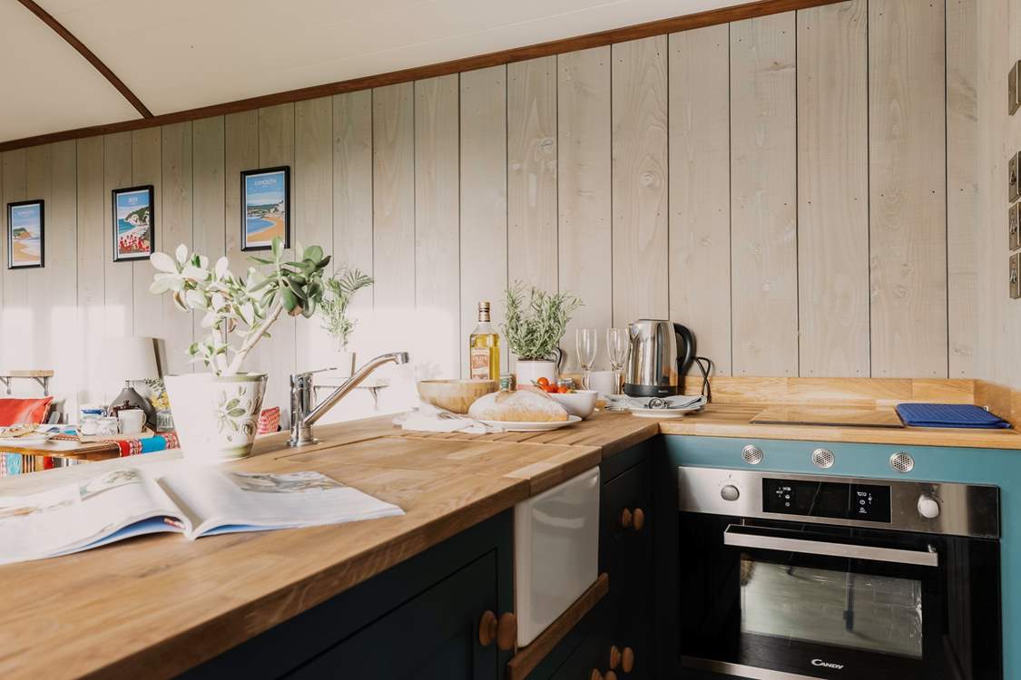 Rustle up a delicious meal in the kitchen, covering the sink for extra countertop space!