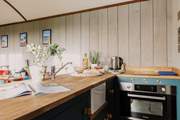 Rustle up a delicious meal in the kitchen, covering the sink for extra countertop space!