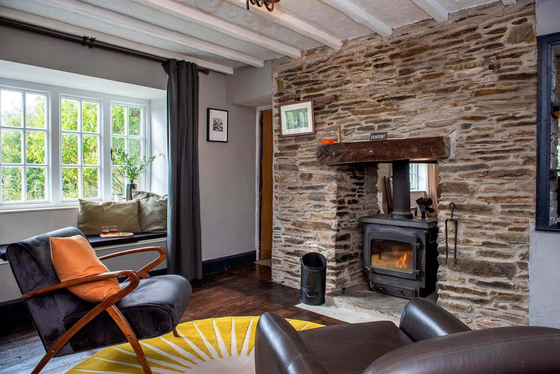 The toasty wood-burner sits between the sitting/dining-room and snug.