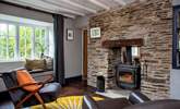 The toasty wood-burner sits between the sitting/dining-room and snug. - Thumbnail Image