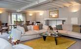 The spacious sitting/dining-room has plenty of space for all to gather and relax. - Thumbnail Image