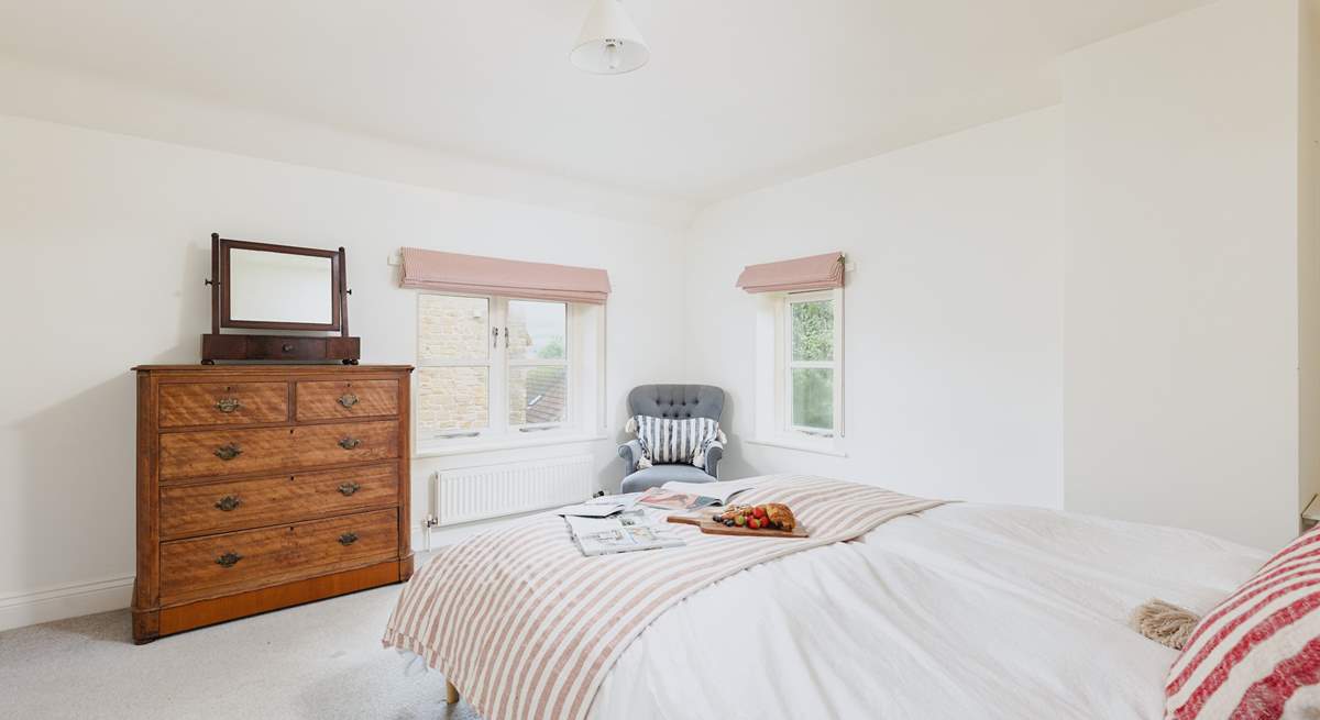 The beautiful main bedroom is flooded with light.