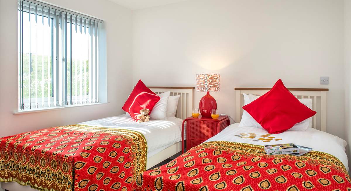 Wonderfully bright throws and cushions adorn the beds in the twin bedroom (6)