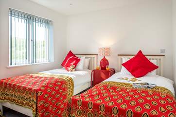 Wonderfully bright throws and cushions adorn the beds in the twin bedroom (6)