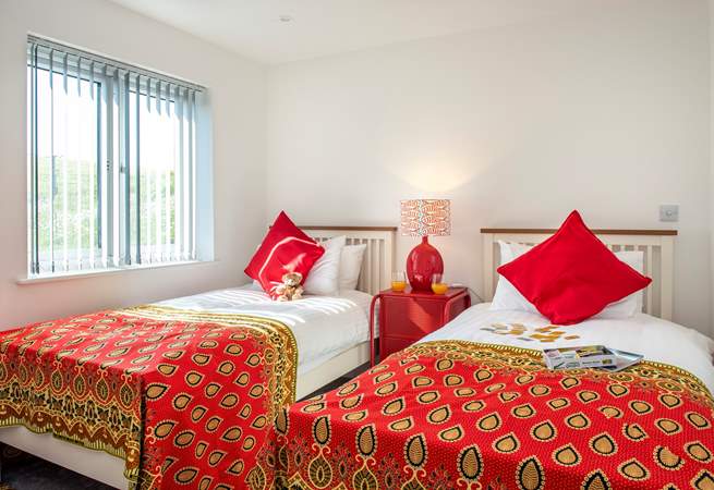 Wonderfully bright throws and cushions adorn the beds in the twin bedroom (6)