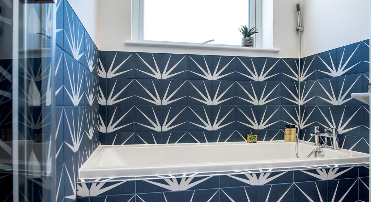 The stylish family bathroom has a lovely bath for a leisurely holiday soak and separate shower cubicle