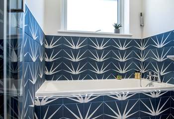 The stylish family bathroom has a lovely bath for a leisurely holiday soak and separate shower cubicle