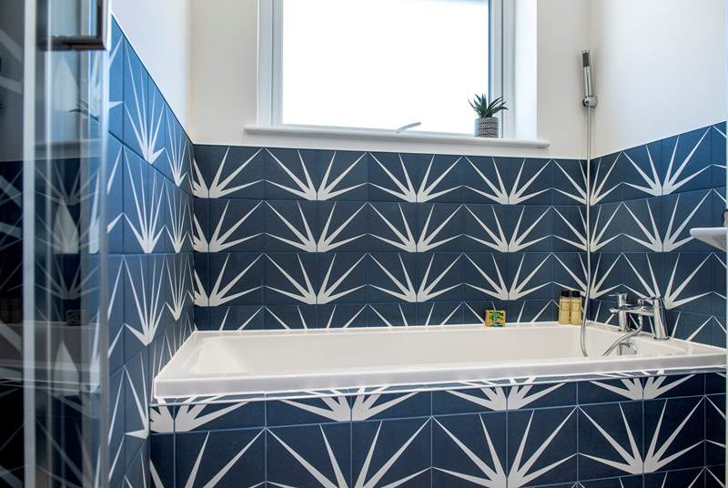 The stylish family bathroom has a lovely bath for a leisurely holiday soak and separate shower cubicle