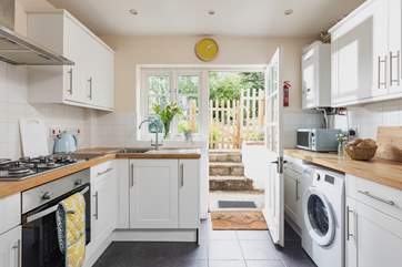The stylish kitchen leads outside, on a warm day take your lunch into the garden.
