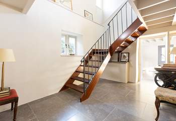The impressive staircase leads up to the cottage bedrooms.