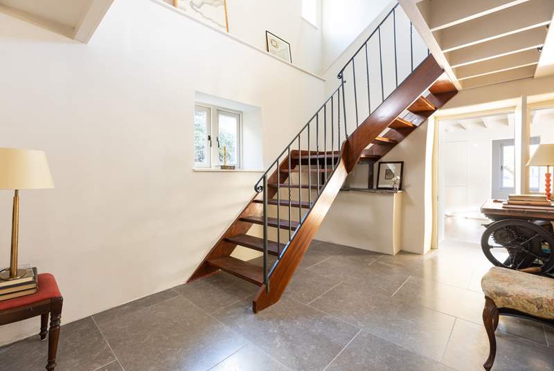 The impressive staircase leads up to the cottage bedrooms.