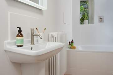 The ensuite bathroom has a bath with an overhead shower