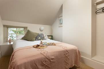 The bed sits nice and cosy under the eaves
