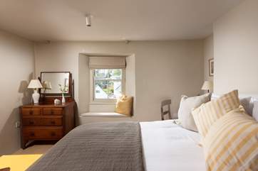 Lovely throws and plump cushions adorn the beds