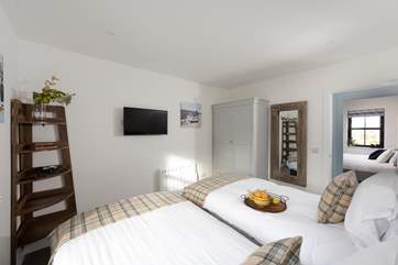 This delightful bedroom even has a TV.