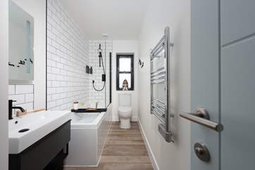 The fabulous family bathroom has a bath for a long soak with a shower over for a refreshing shower.