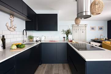 The sociable living space includes this super sleek kitchen.