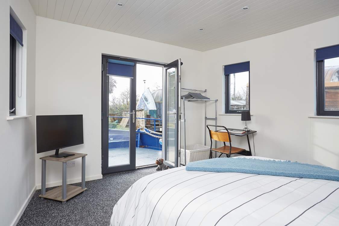 Bedroom 1 on the main deck with en suite shower-room also benefits from patio doors leading to the outer deck.