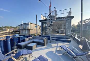 Plenty of outdoor seating is on the main deck (please note, the sunloungers have now been replaced with deck chairs). The spiral staircase leads to the upper deck which boasts fantastic views.