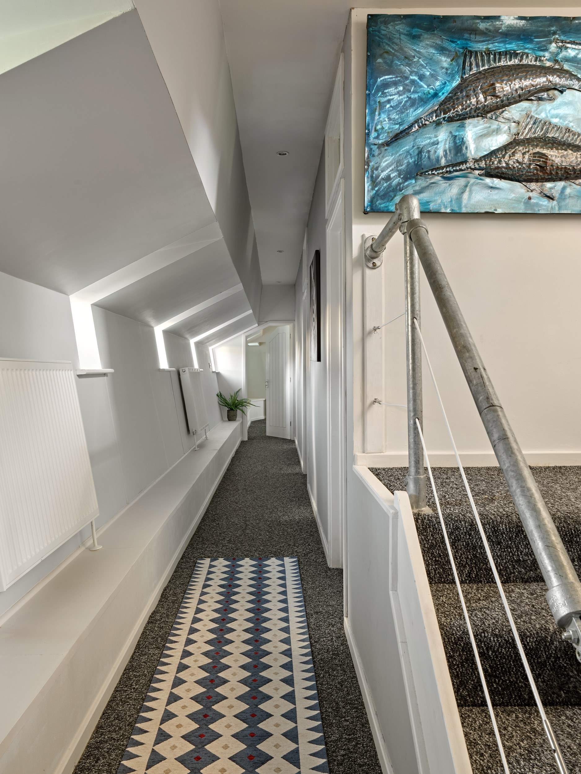 Stairs lead to the lower deck and bedrooms 2 & 3. 