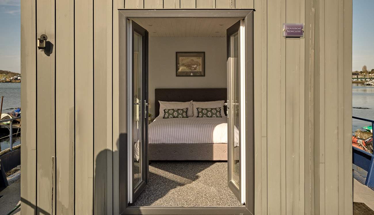 Bedroom 1 on the main deck benefits from patio doors leading to the outer deck as well as an en-suite.