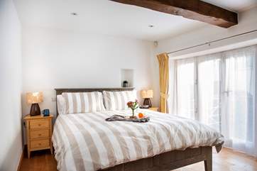The second bedroom is downstairs next to the family bathroom, and has a king-size bed.