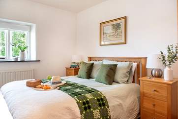 Bedroom one is on the entrance level of Tredis House Barn.