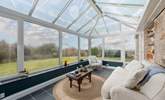 Enjoy a morning cuppa in the conservatory whilst younger members play in the garden. - Thumbnail Image