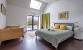 The ground floor bedroom with king-size bed, single bed and double doors that lead to the terrace and garden. - Thumbnail Image