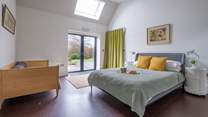The ground floor bedroom with king-size bed, single bed and double doors that lead to the terrace and garden.