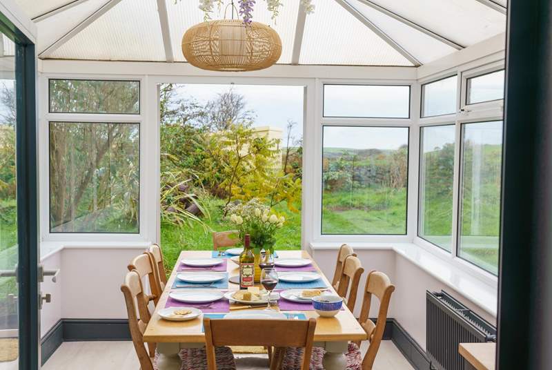 The conservatory has a lovely dining-table - perfect for gathering together to enjoy holiday meals.