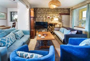 The sitting-room is wonderfully cosy with two comfortable sitting areas and a cosy wood burner. 