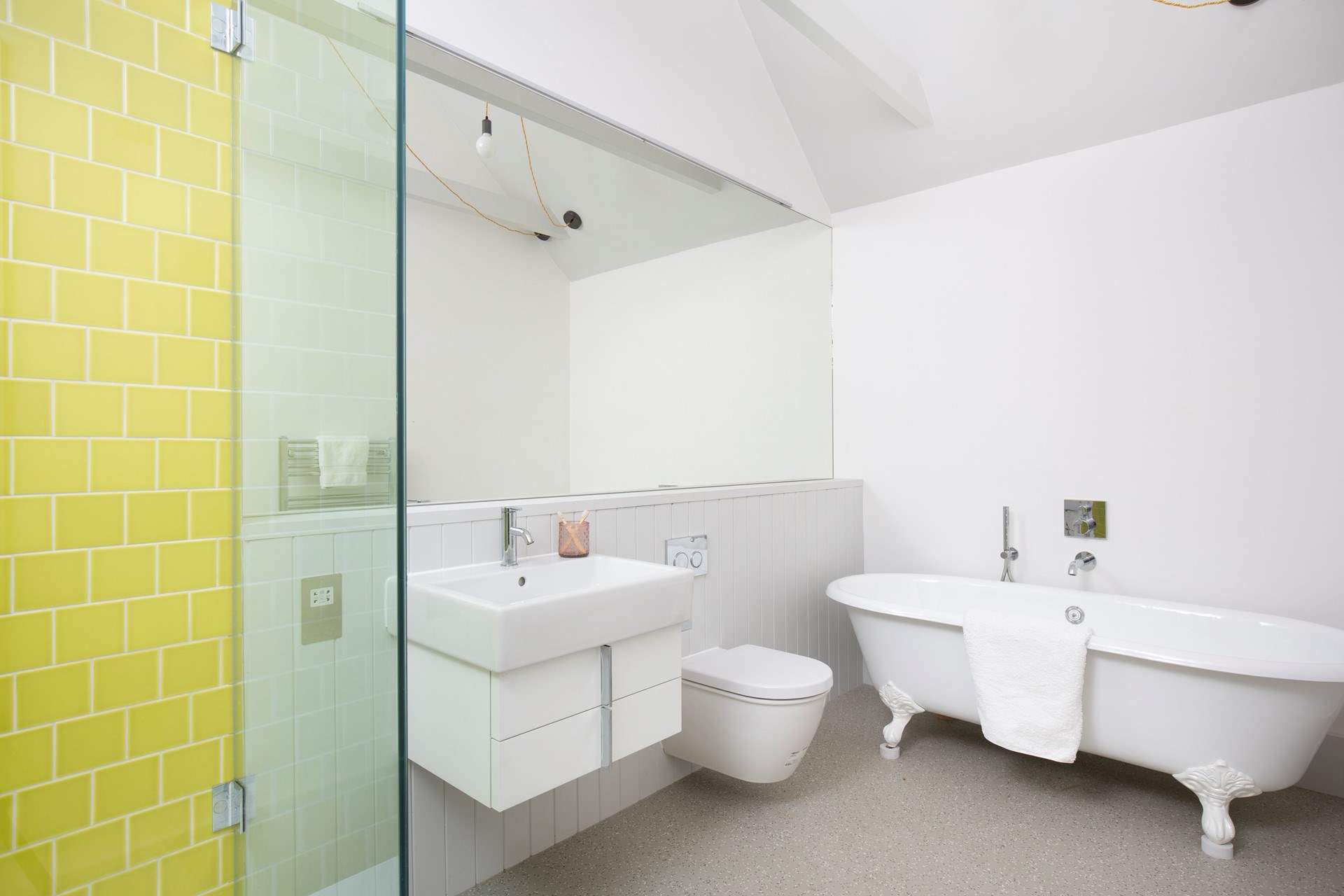 The en suite bathroom has a free-standing bath and walk-in shower.