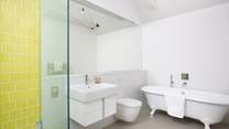 The en suite bathroom has a free-standing bath and shower.
