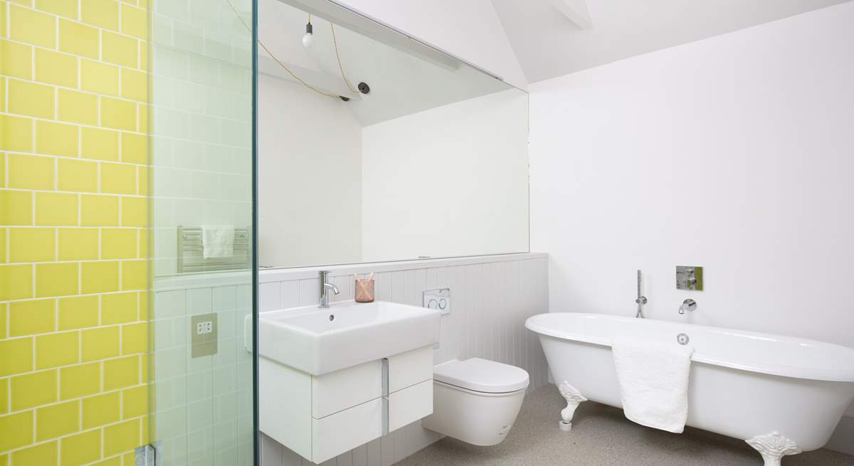 The en suite bathroom has a free-standing bath and walk-in shower.